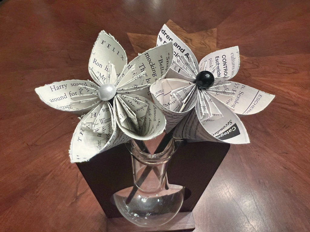 A bouquet of paper flowers with white pearl centers.